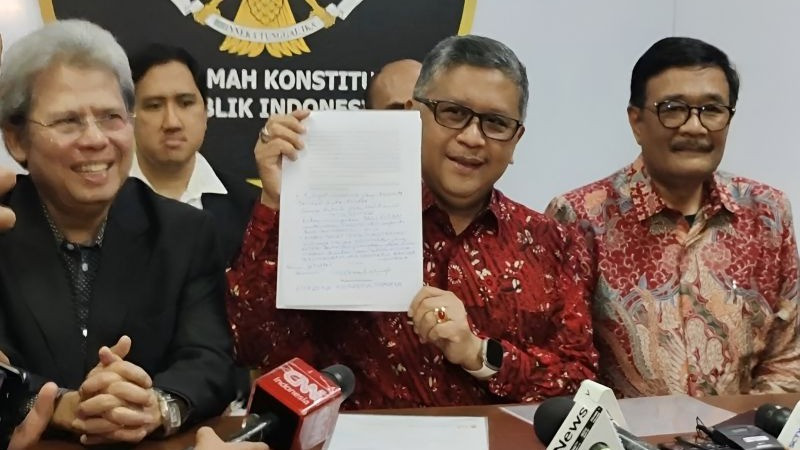 Hasto Kristiyanto menunjukkan surat Amicus Curiae Megawati Soekarnoputri 