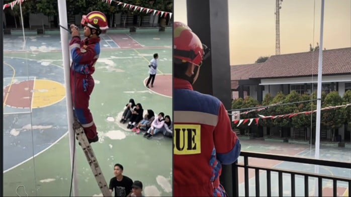 Petugas Pemadam Kebakaran membantu siswa SMA untuk menurunkan bendera Merah Putih